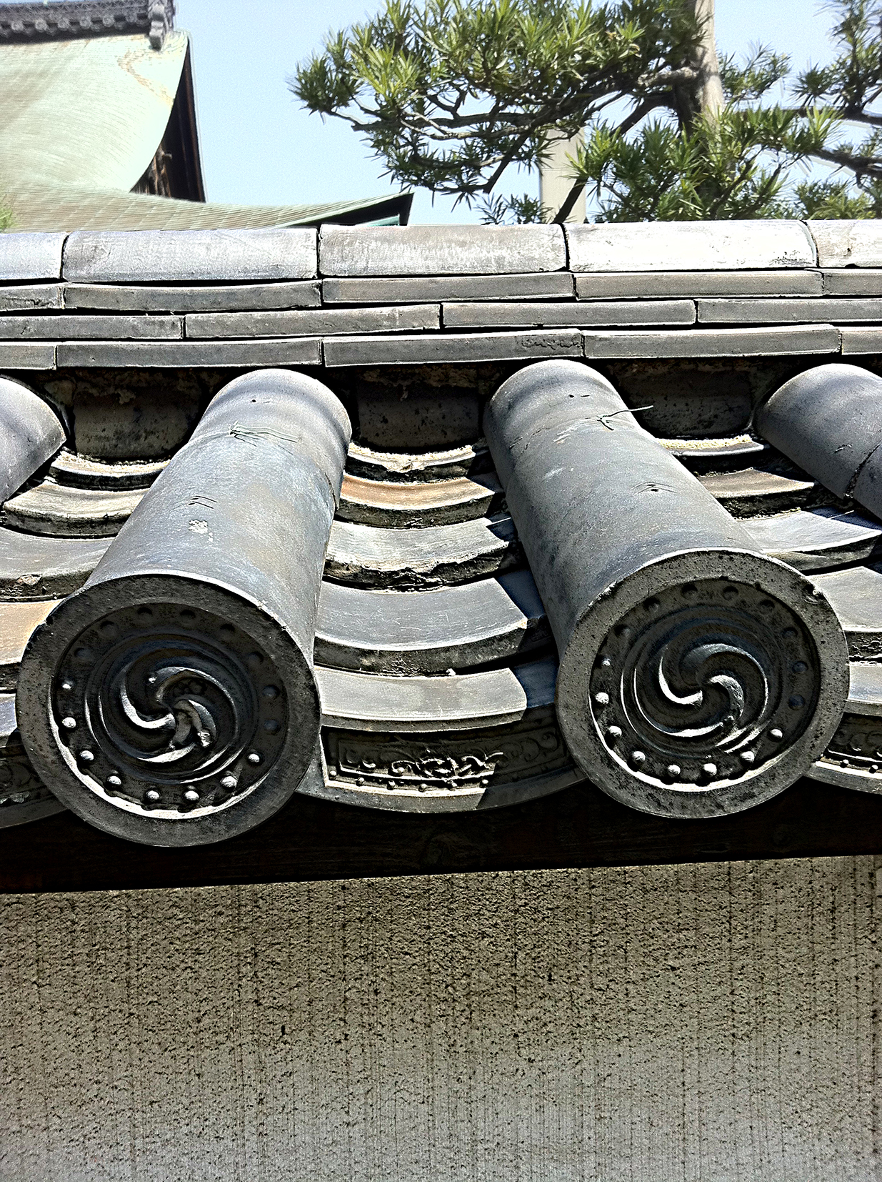 close up of the patterned ends of traditional grey Japanese roof tiles